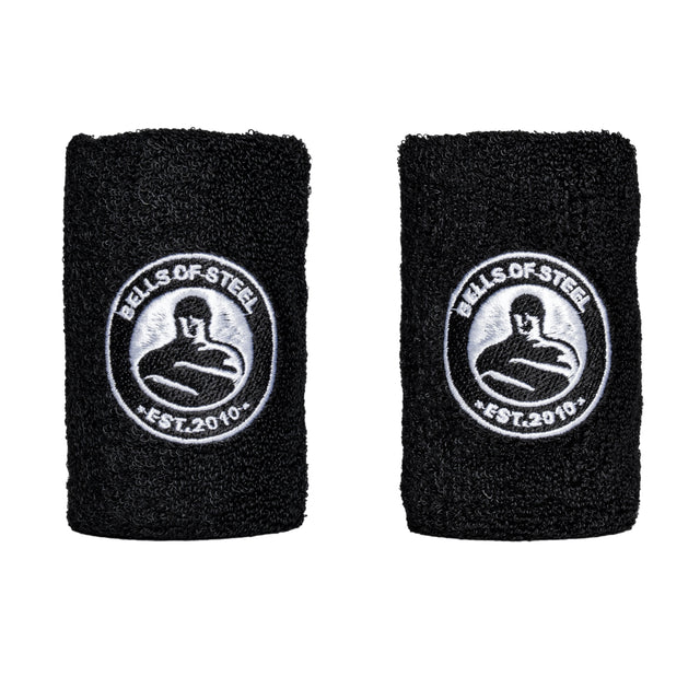 The Bells of Steel Wildman Swing Program Kettlebell Bundle includes two black wristbands featuring a stylized strongman logo and "EST. 2010" embroidered in white, perfect for enhancing your kettlebell swing routine.
