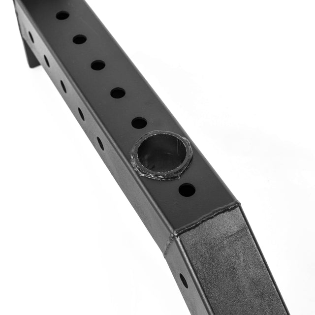 Close-up of a black metal Front Foot Stabilizer by Bells of Steel, showing a row of round holes and a welded circular barbell storage opening, set against a white background.