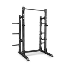 The Bells of Steel Manticore Half Rack - Prebuilt (3" x 3", 1" Holes) is a black metal half rack featuring 3x3 uprights, adjustable safety bars, pull-up bar, and weight plate storage pegs—designed for weightlifting and strength training exercises in your home gym.
