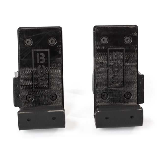 Two black, wall-mounted Standard J-Cups by Bells of Steel, each with “BOS” embossing. Four-screw install, rectangular backplate, curved lip, and built-in UHMW protection safeguard your equipment in power rack setups.
