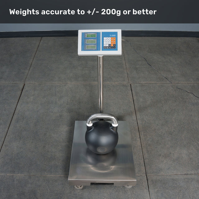 A digital scale sits on a gray tiled floor, displaying a weight as it holds a Bells of Steel Competition Kettlebell. The screen reads “Weights accurate to +/- 200g or better,” giving users confidence when consulting any kettlebell weight guide.