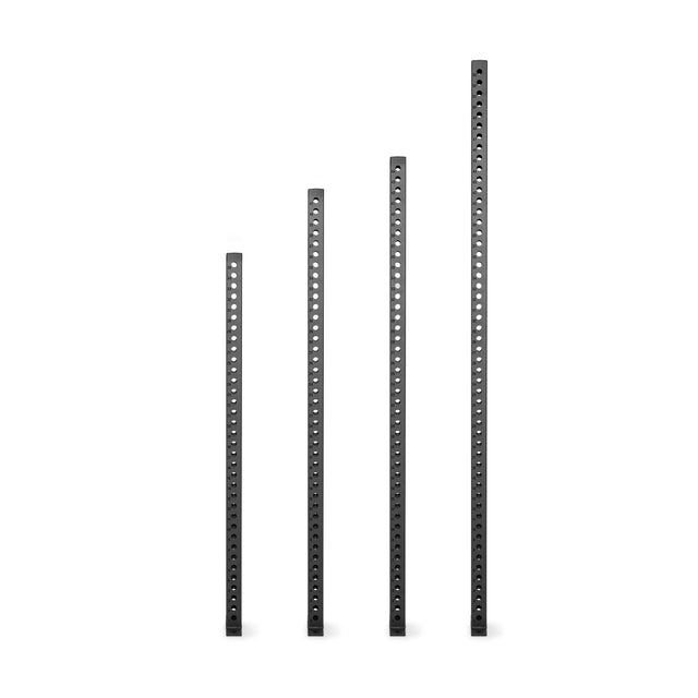 Four black metal bars of different heights with evenly spaced holes, arranged in ascending order on a white background—these are Manticore Vertical Uprights from Bells of Steel, ideal as power rack uprights.