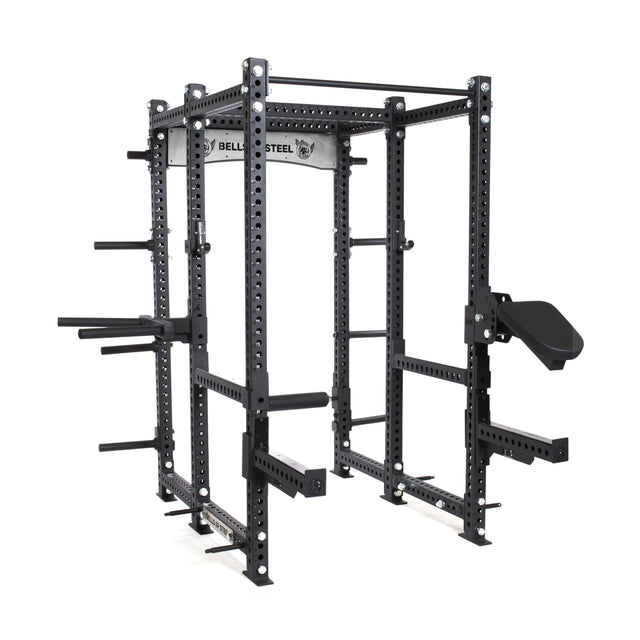 The Manticore Six Post Power Rack features black steel, modular components, adjustable bars, and multiple attachment points. It includes pegs for weight storage, a pull-up bar at the top, and prominently displays the Bells of Steel brand near the top.