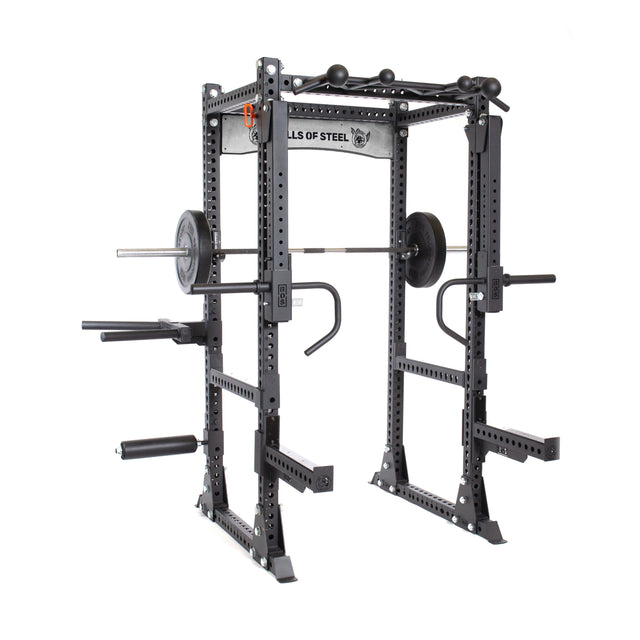 The Bells of Steel Manticore Flat Foot Power Rack - Prebuilt (3"x3", 1" holes) is a black power rack with safety bars, pull-up bars, dip handles, and a loaded barbell—ideal for home strength training and weightlifting.