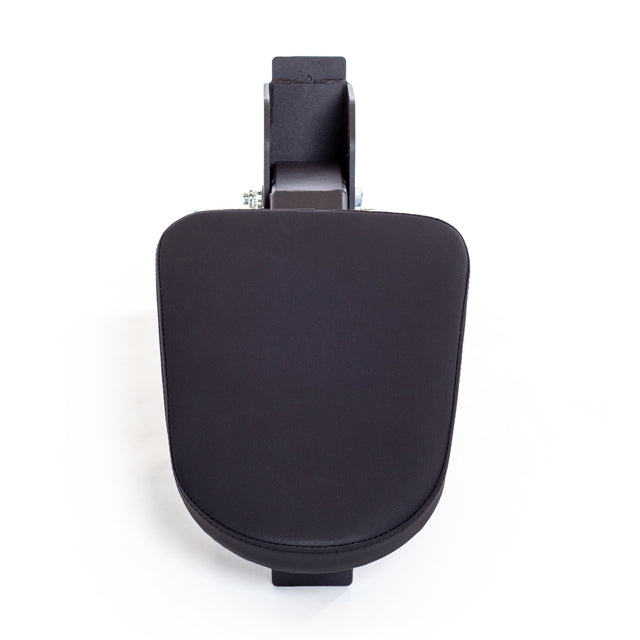 A top-down view of the Bells of Steel Seal Row Pad Rack Attachment—a black, padded armrest with a rectangular mounting bracket—resembles a chest support pad and is isolated on a white background.