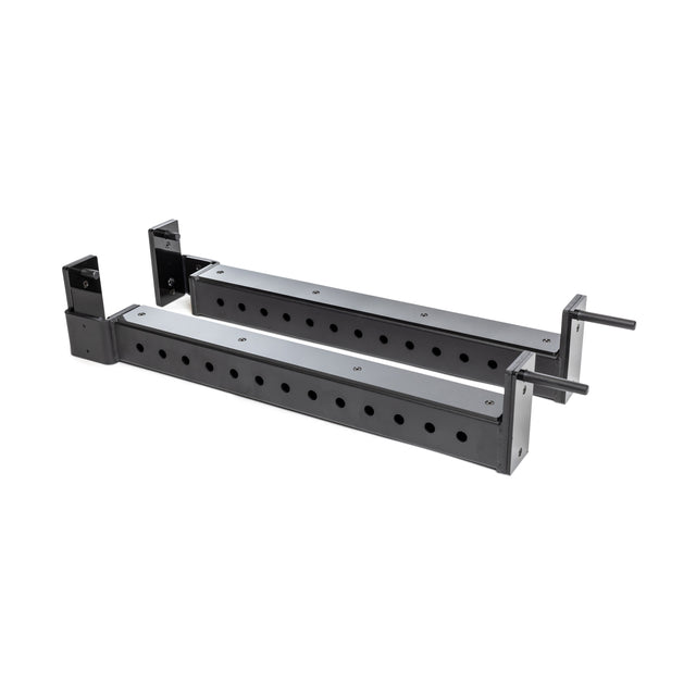 The Bells of Steel Flip-Down Safeties are two black metal adjustable brackets with multiple mounting holes, designed for power rack training safety and equipment support, shown on a white background.