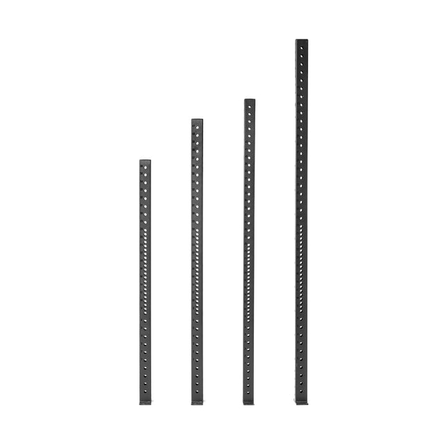 Four vertical Hydra Vertical Uprights by Bells of Steel, in black metal with different heights and evenly spaced holes, stand side by side against a white background.