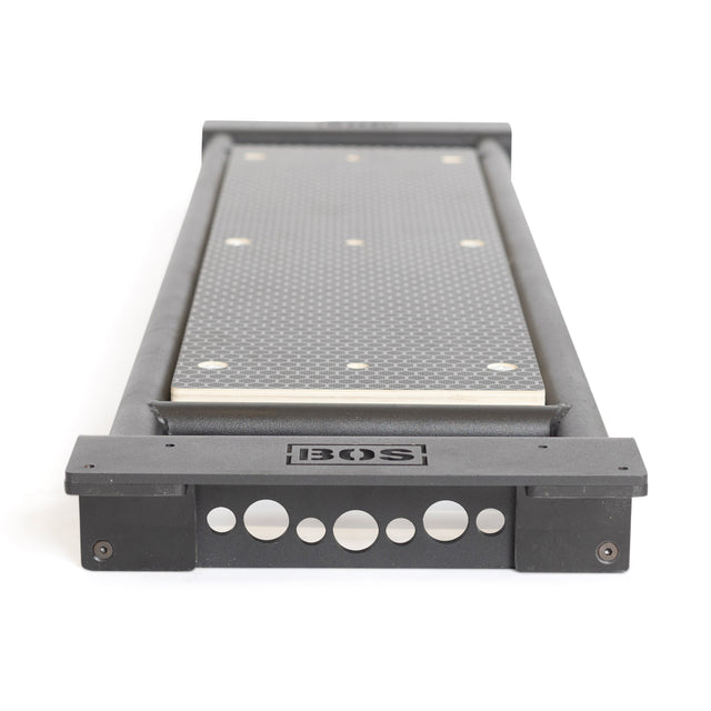 The Bells of Steel Utility Seat for Hydra/Manticore features a textured black surface, metal edges, and a black frame with circular cutouts and the BOS logo—ideal for pairing with a 3"x3" rack or upgrading your adjustable workout bench.