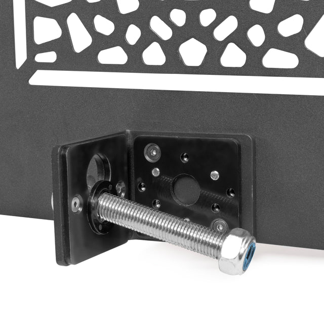 Close-up of a metal bracket with bolt and nut secured to a black surface with geometric cutouts, designed for the Bells of Steel Rack Attached Basketball Hoop w/ Ball—ideal for adding basketball fun to your home gym power rack.