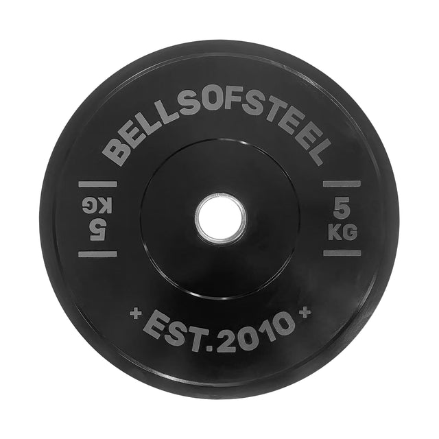 A black Dead Bounce Conflict Bumper Plate by Bells of Steel, labeled "5 KG," "KG," and "EST. 2010" in white, with a central hole for weightlifting bars.