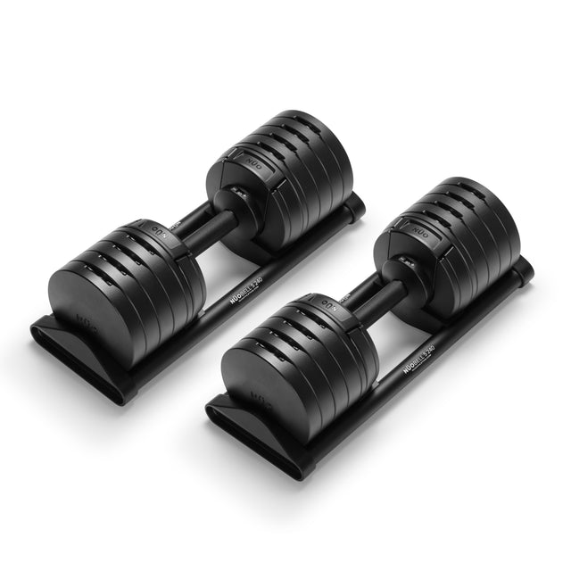 The NÜOBELL-S Adjustable Dumbbells by Bells of Steel feature multiple weight settings and rest on sleek black trays—an ideal, space-saving addition to any home gym.