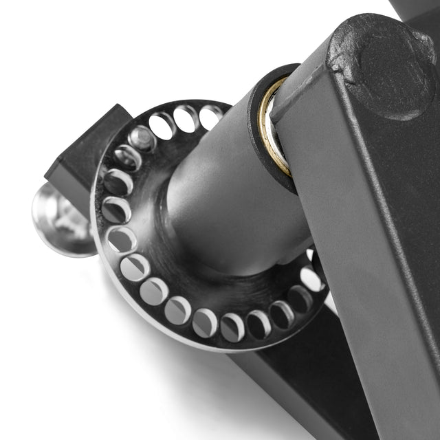 Close-up of the Bells of Steel Shoulder Boulder/Chest Fly Attachment, showing its metallic hinge mechanism with circular holes—an adjustable accessory for strength equipment.