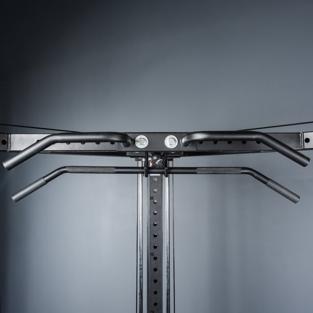 A close-up of the Bells of Steel All-in-One Trainer shows a pull-up bar with multiple grip options mounted on a black metal power rack—ideal for any home gym setup—against a gray background.