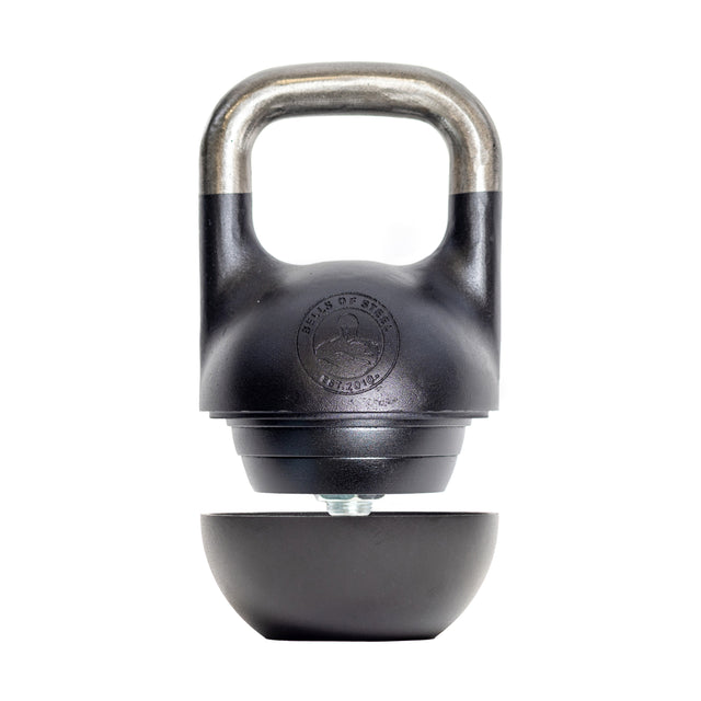 The Bells of Steel 6-12KG Adjustable Kettlebell, inspired by Mark Wildman, features a black competition-style design with a partially detached bottom revealing its adjustable mechanism, shown on a white background.