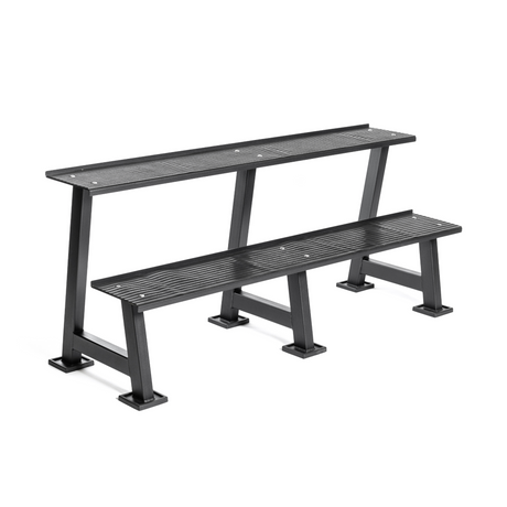 A black metal bench with two staggered tiers, each with slatted seats and sturdy, rectangular legs, designed for outdoor or public seating.