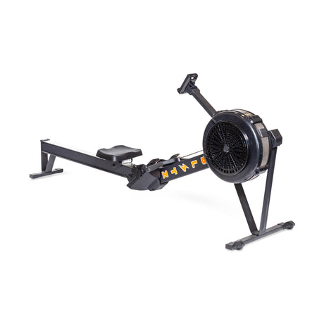 A black rowing machine with a fan flywheel, footrests, handle, and sliding seat, designed for indoor cardio workouts on a white background.