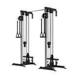 The Bells of Steel Cable Tower Squat Stands are black and silver dual adjustable pulley machines with weight stacks, handles, a pull-up bar, and multiple attachment points for strength training exercises.