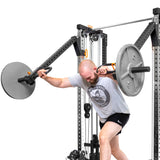 A man in athletic wear does a landmine press on Bells of Steel Cable Tower Squat Stands, pressing a loaded barbell overhead from a lunging stance.