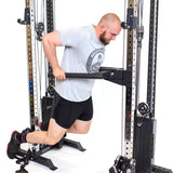 A person in gray t-shirt and black shorts does dip exercises with a dip bar on the Bells of Steel Cable Tower Squat Stands in a gym.