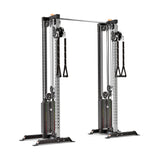 The Bells of Steel Cable Tower Squat Stands feature adjustable pulleys, dual weight stacks, handles, and a sturdy metal frame—making them versatile equipment for strength training exercises.