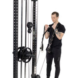 A man in black workout clothes performs a bicep curl using a cable machine, gripping Bells of Steel Adjustable Length Aluminum Handles. The white background highlights these premium gym accessories.