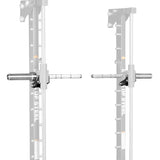 Two Anvil Handles by Bells of Steel, designed as Smith Machine Handles, are attached to a squat rack and face each other. The handles are silver with black brackets, while most of the squat rack is faded out in the background.