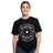 A woman smiles in a Bells of Steel Bamboo T-Shirt, which features a white "BELLS OF STEEL 25 KG" weight plate graphic on the front. She stands against a plain white background.