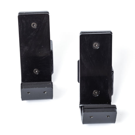 Two Standard J-Cups by Bells of Steel, in black metal with three visible screws each, stand upright on a white background, resembling sturdy power rack accessories.
