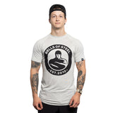 A man in a backward black cap and light gray Bells of Steel Bamboo T-Shirt stands facing forward, displaying tattooed arms, against a plain white background.