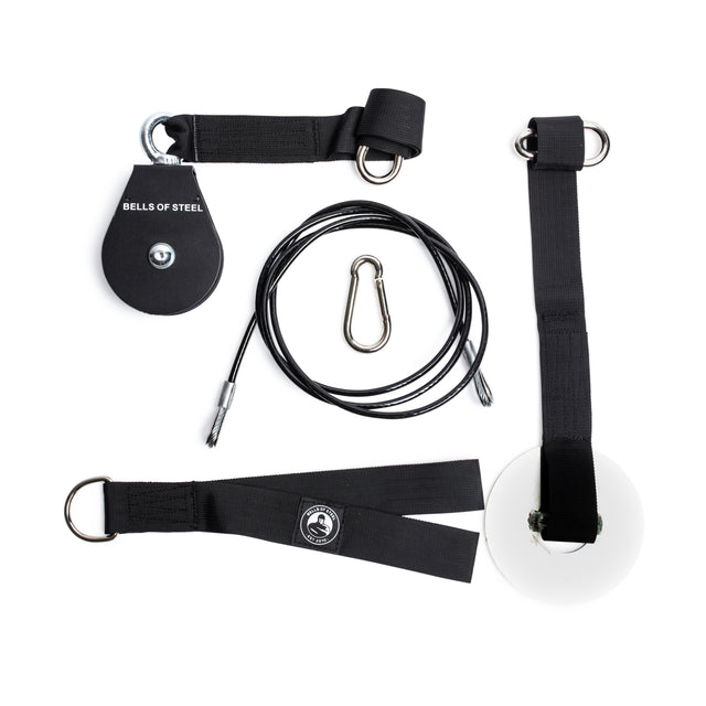 The Bells of Steel Cable Pulley set includes a black pulley, steel carabiner, cable, white loading pin, and black straps with metal rings—ideal for lat pulldowns and tricep pushdowns—displayed on a white background.
