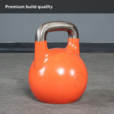 A 28 kg (62 lb) orange Bells of Steel Competition Kettlebell with a metallic handle rests on a gray floor. The phrase “Premium build quality” is displayed at the top on a gray banner, emphasizing the consistent size and colour-coded design of these Competition Kettlebells.