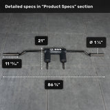 The Bells of Steel Safety Squat Bar - The SS4, featuring padded handles, rests on a gray tiled floor. Text boxes show: 86 5/8" length, 21" width, 1 1/4" sleeve diameter, and 11 13/16" handle spacing.