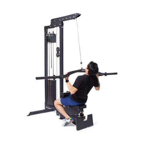 Wearing athletic gear, a user demonstrates the Bells of Steel Lat Pulldown Low Row Machine by pulling a wide bar toward their chest, highlighting this versatile home gym equipment against a white background.