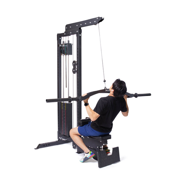 Wearing athletic gear, a user demonstrates the Bells of Steel Lat Pulldown Low Row Machine by pulling a wide bar toward their chest, highlighting this versatile home gym equipment against a white background.