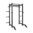 The Bells of Steel Manticore Collegiate Power Rack Builder features 3"x3" uprights, 1" holes, plate storage pegs, and a pull-up bar—ideal for any home gym setup. "BELLS OF STEEL" is labeled on the front crossbar.