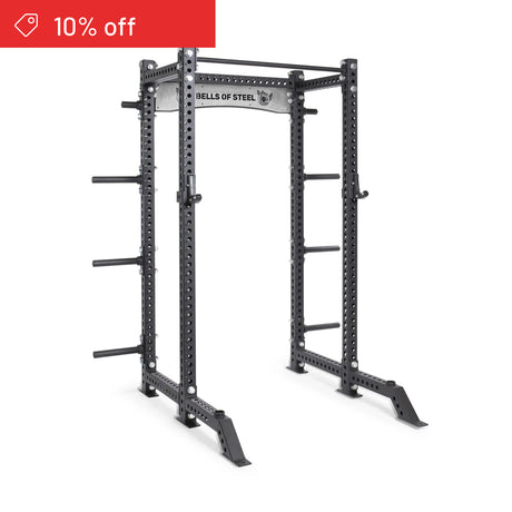 A Bells of Steel Manticore Collegiate Power Rack Builder (3" x 3", 1" holes) in black, features attachment points and weight storage pegs—shown on a white background with a red “10% off” label—perfect for home gyms.