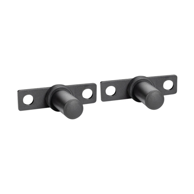 Two black Bells of Steel Bolt-On Plate Pegs, cylindrical with flat mounting plates and screw holes, are displayed side by side on a white background.