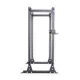 The Bells of Steel Manticore Flat Foot Power Rack - Prebuilt (3" x 3", 1" Holes) is a black metal rack with a rectangular base and four vertical posts, ideal for weightlifting and strength training in any home gym.