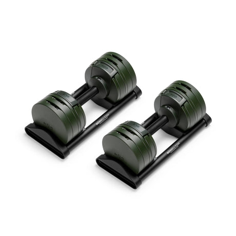 The Bells of Steel NÜOBELL-S Adjustable Dumbbells feature dark green weight plates, black handles, and matching black trays—ideal for any home gym and shown on a white background.