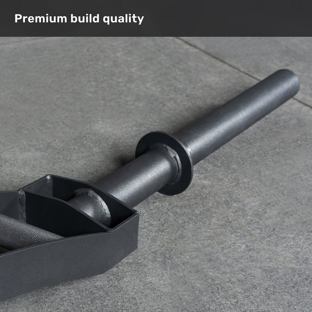 A close-up of a black barbell sleeve and collar on gray concrete highlights the premium build quality of the Bells of Steel Arch Nemesis Swiss Bar, perfect for specialty barbell training.