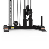 The Bells of Steel Cable Tower features an adjustable weight stack, pulleys, cables, safety warning labels, and a foot support platform, shown on a white background.