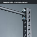 Close-up of the Bells of Steel Manticore Squat Stand Builder, featuring black 3" x 3" metal uprights with 1" holes, numbered laser-cut markings, and sturdy bolts—showcased against a gray background with "11 gauge steel with laser cut numbers" at the top. Perfect for any home gym or squat stand setup.