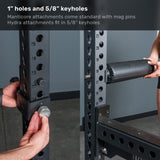 Sure! Here is a rewritten version of the sentence using your provided product data: A close-up of the Bells of Steel Manticore Squat Stand – Prebuilt (3" x 3", 1" Holes) shows a person inserting a BOS mag pin into 1” holes on the uprights. Another person attaches a padded accessory to the rack, demonstrating how easily it adapts for any home gym or squat stand. Text at the top describes hole and keyhole sizes for compatible attachments.