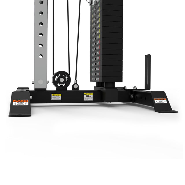 Close-up of the lower section of the Bells of Steel Cable Tower gym machine, featuring a weight stack, pulleys, cables, sturdy metal frame, adjustable handles, and warning labels. The equipment is shown against a white background.