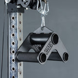 A close-up of the Bells of Steel Fat Bar - T-Bar Row Cable Attachment, a black metal grip strength tool, hangs from a carabiner with its engraved branding visible against a gray background.