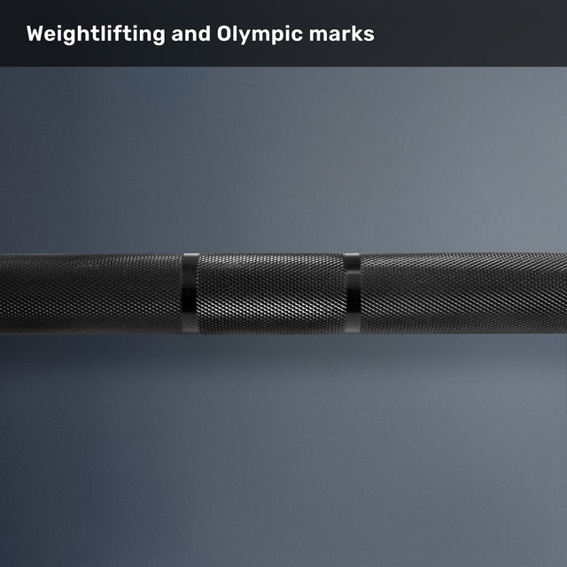 Close-up of the Bells of Steel Multi-Purpose Olympic Barbell – The Utility Bar, highlighting its knurled grip and clear Olympic and weightlifting markings on a gradient gray background.