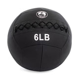 The Bells of Steel's Triple Stitched Medicine Ball is black with a Kevlar outer shell, visible logo, crisscross stitching, labeled "6 LB," and part of a collection with various weights.