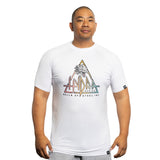 A man wearing a Bells of Steel Bamboo T-Shirt featuring a sweat-wicking fabric, colorful geometric logo, dragon graphic, and the text "HYDRA SERIES" stands against a plain white background.