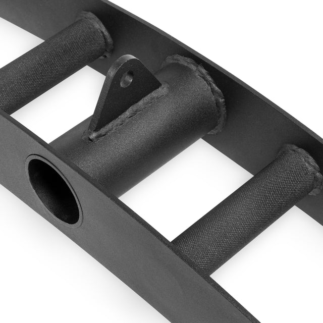 Close-up of the Bells of Steel Arch Nemesis Tricep Bar, featuring textured cylindrical grips, a central circular opening, and a welded triangular bracket for cable attachment. Its matte black metal finish underscores its durable design.
