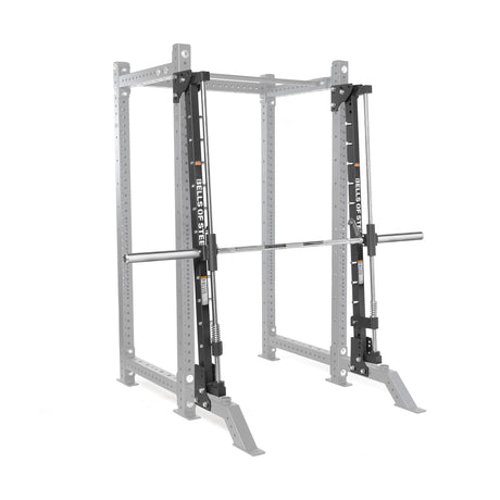The Bells of Steel Smith Machine Rack Attachment, shown in silver with a barbell, is designed for weightlifting and strength training. The equipment is displayed against a plain white background.
